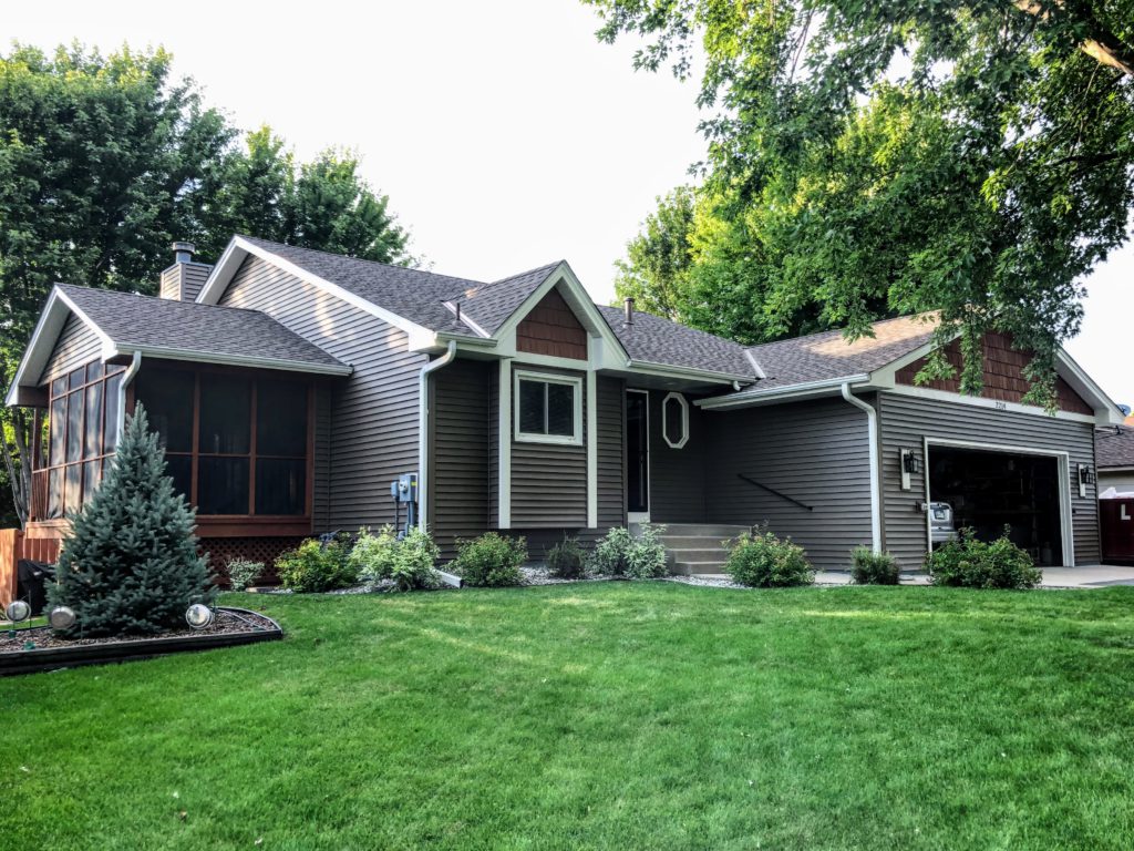 brown house on green lawn shows quality repairs after storm damage